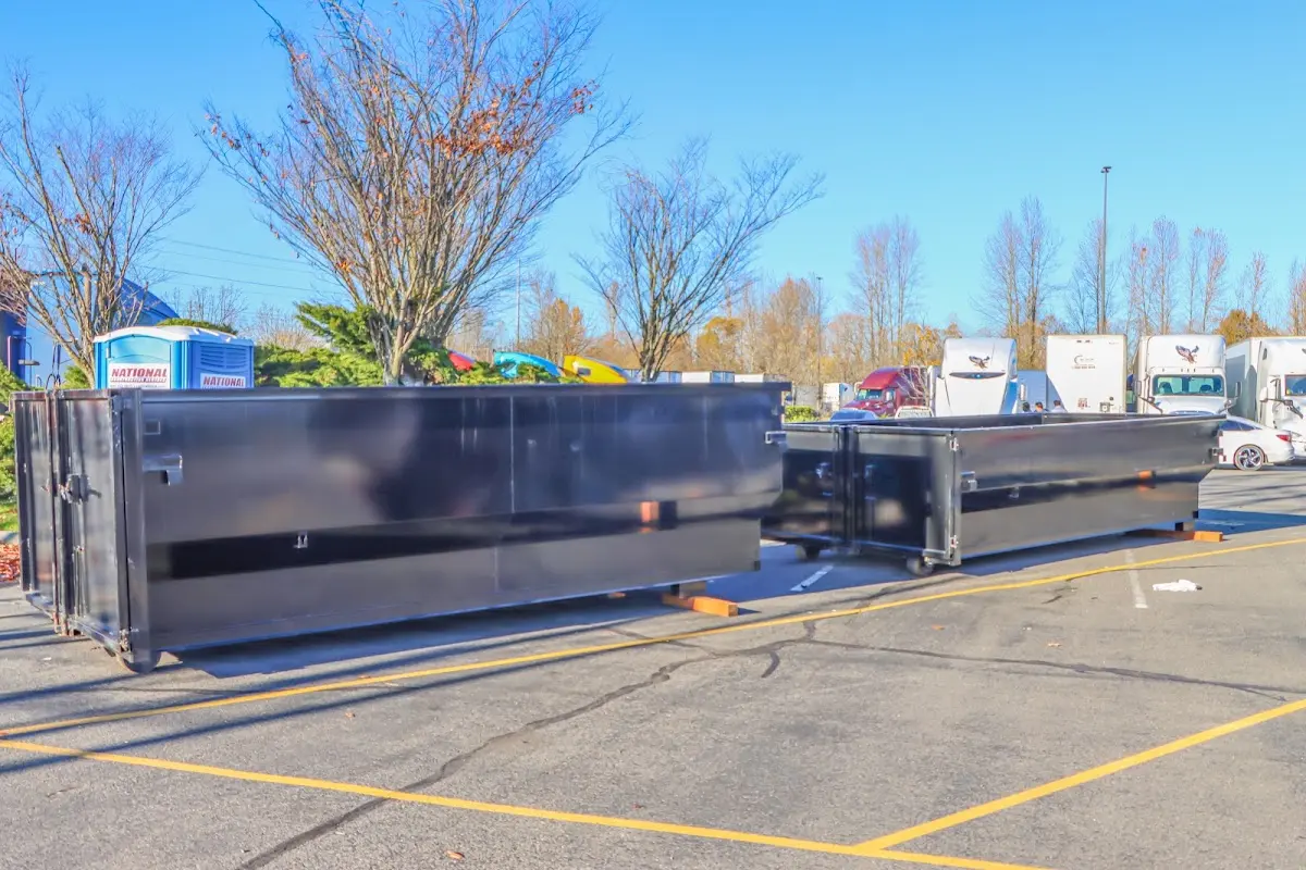 Professional dumpster rental service with roll-off container on residential driveway in Morehead City